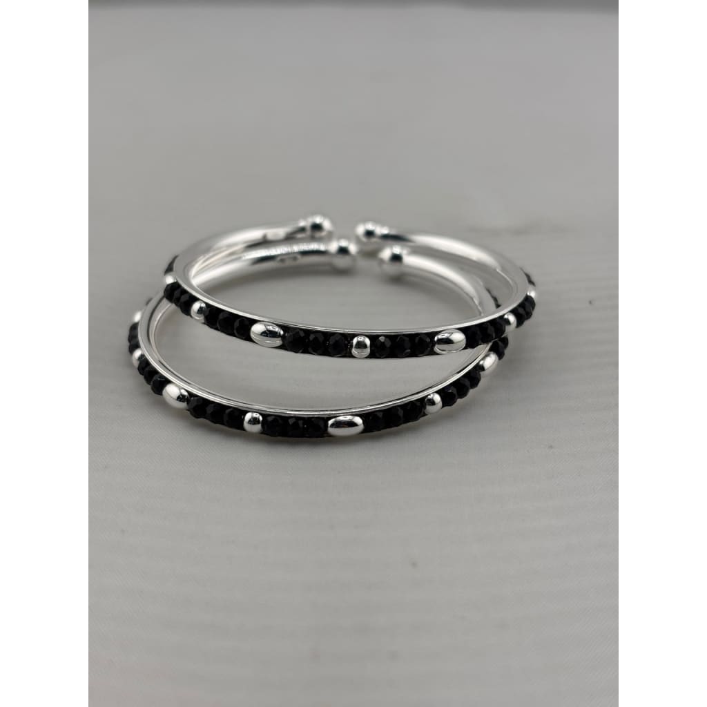 925 sterling silver kids bangle pair close-up showing black bead and silver accent pattern