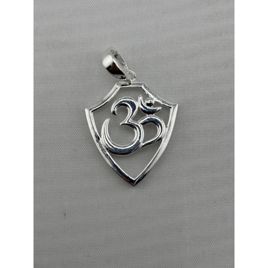 Close-up of a polished 925 sterling silver Om pendant in a shield-shaped frame