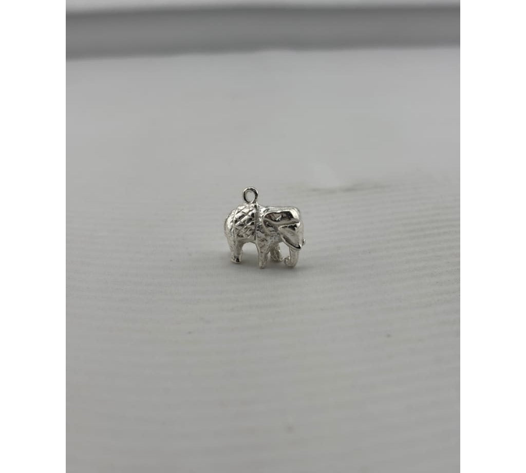 Original three-quarter view of a silver standing elephant pendant with curled trunk
