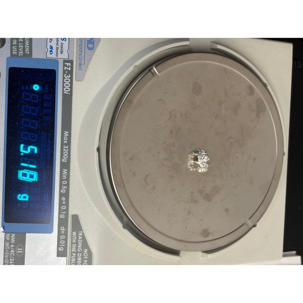 Standing elephant pendant on a digital scale showing a weight of 5.18 grams