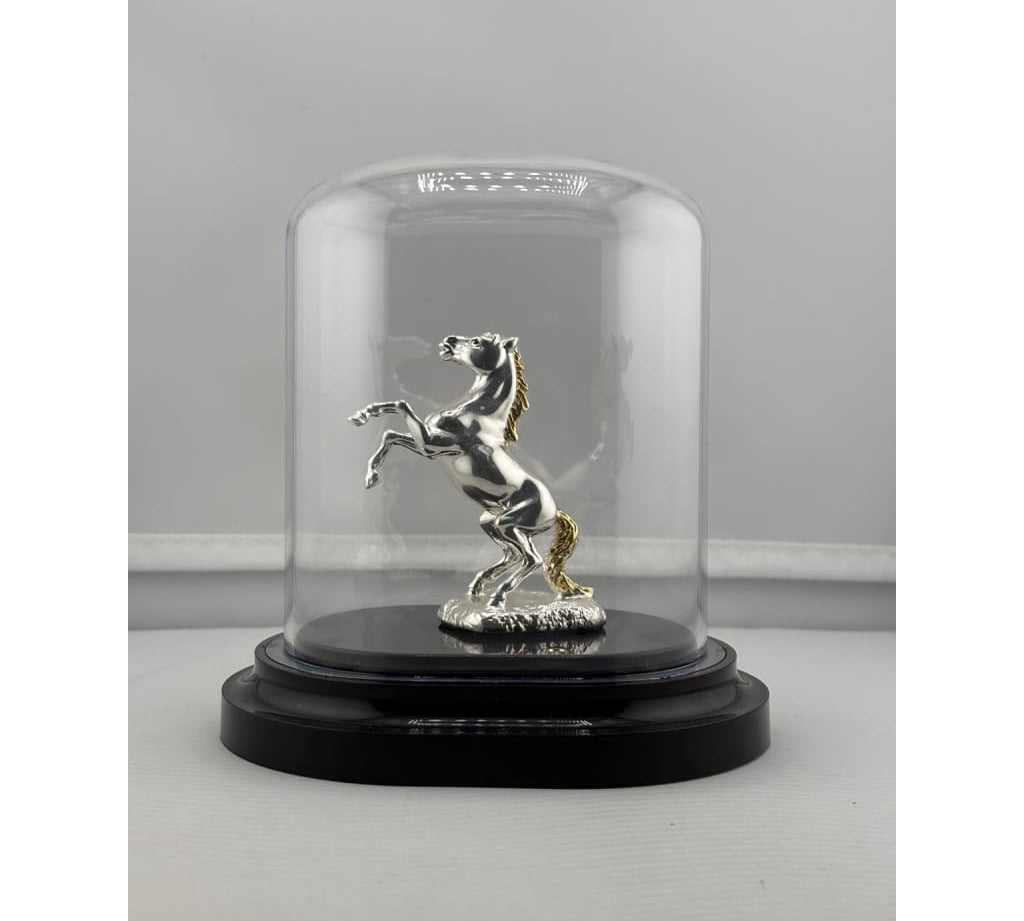 Front view of pure silver horse figurine in acrylic dome