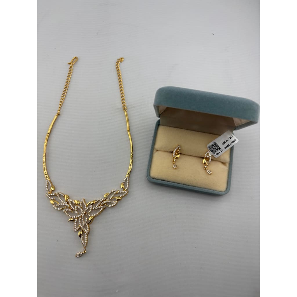 Gold-plated layered leaf necklace with matching clear-stone drop earrings