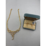 Gold-plated layered leaf necklace with matching clear-stone drop earrings