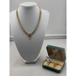 Gold-plated crystal floral necklace and matching earrings on jewellery display