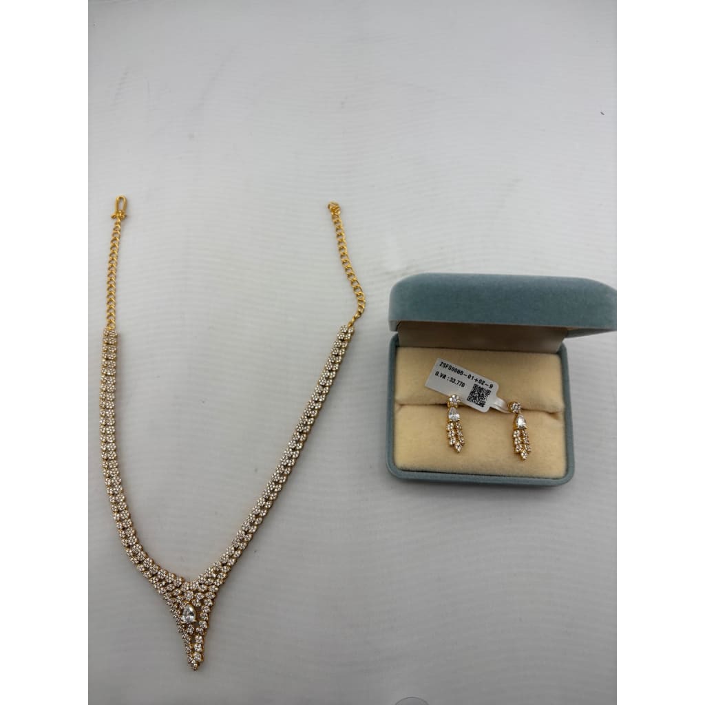 Gold-plated floral crystal necklace and matching drop earrings set