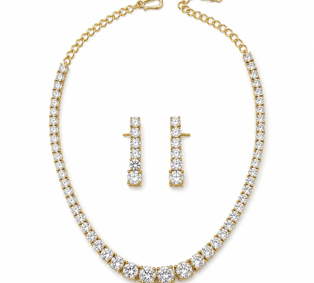 Gold-plated 925 sterling silver graduated tennis necklace and earrings set on white background
